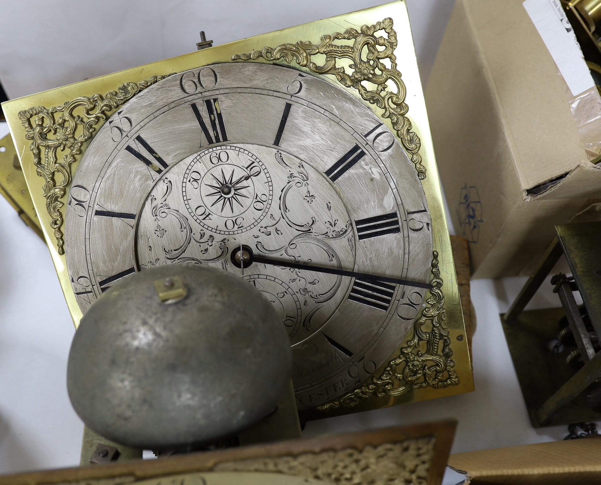 A large quantity of clock parts, to include movements, dials etc., including a John Marshall of Chulmleigh clock face